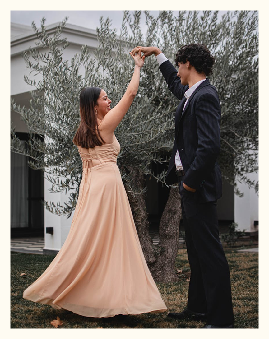 A couple dancing outdoors at golden hour